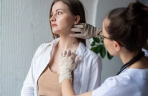 Dermatologist examining a woman’s neck scar for scar revision treatment in Faridabad